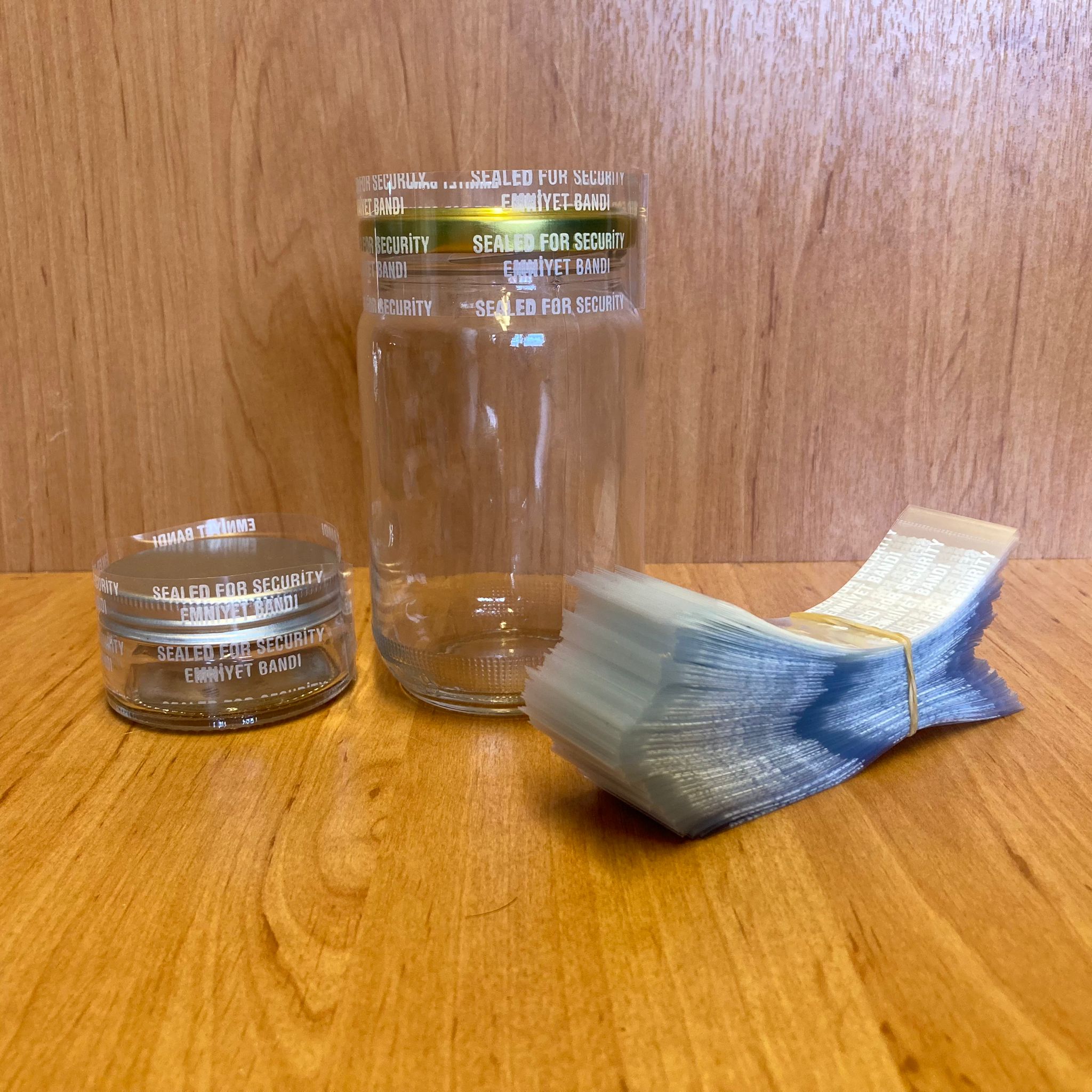 Emniyet Bandı 57 Mm, 58 Mm Ve 63 Mm Ağız Uyumlu - 100 Gr - (Yaklaşık 190 Adet) - Yazılı - Kavanoz Garanti Bantı - Şişe Emniyet Bandı - Kavanoz Güvenlik Bandı